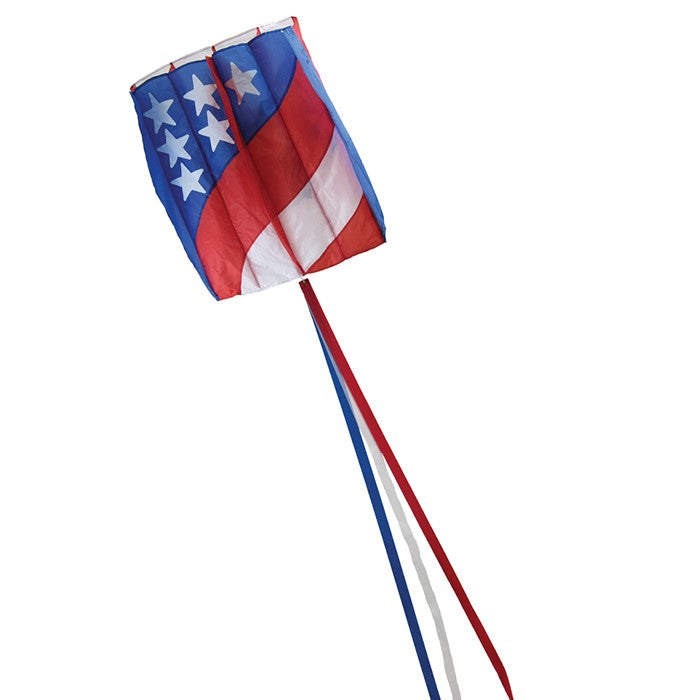 7.5 Patriot Wave Air Foil Kite soaring in the sky with red, white, and blue colors and stars, showcasing its lightweight design and beauty.