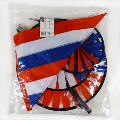 Patriot Wind Sail Triple Wheel Spinner with three colorful wheels and an applique windsail, displayed in an outdoor garden setting, showcasing red, white, and blue colors.