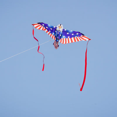 40-inch Patriotic Bald Eagle Bitty Bird Kite with a realistic eagle head and American flag body, displayed flying against a clear blue sky.
