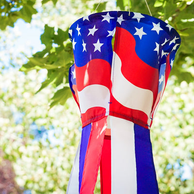Patriotic Spinning Windsock featuring red, white, and blue stars and stripes design spinning in the outdoor breeze, adding vibrancy to the yard.