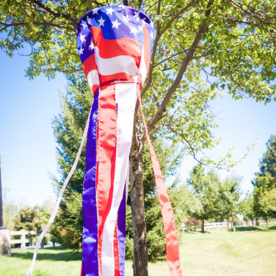 Patriotic Spinning Windsock featuring red, white, and blue stars and stripes design spinning in the outdoor breeze, adding vibrancy to the yard.