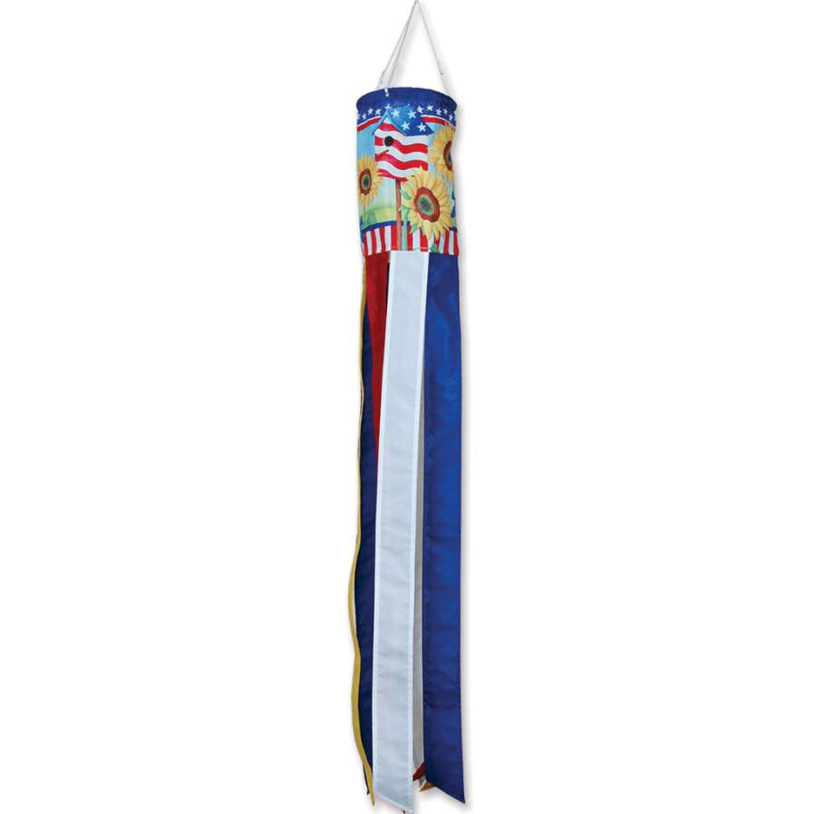 Patriotic Sunflower windsock with bright yellow flowers on a blue and red background hanging elegantly from an outdoor pole in a sunny garden setting.