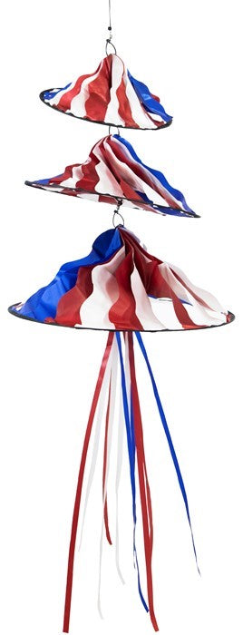 Patriotic Triple Jelly wind decoration featuring three spinning structures in red, white, and blue colors, hanging outdoors in a garden setting.