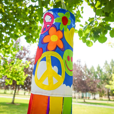 Peace, Love & Happiness 40-inch windsock with psychedelic designs and colorful tails, fluttering in the breeze outdoors.