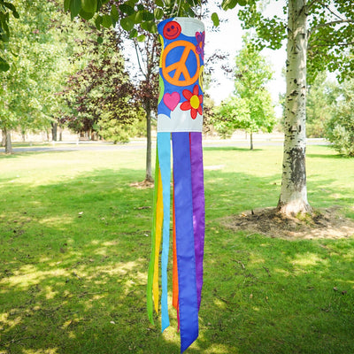 Peace, Love & Happiness 40-inch windsock with psychedelic designs and colorful tails, fluttering in the breeze outdoors.