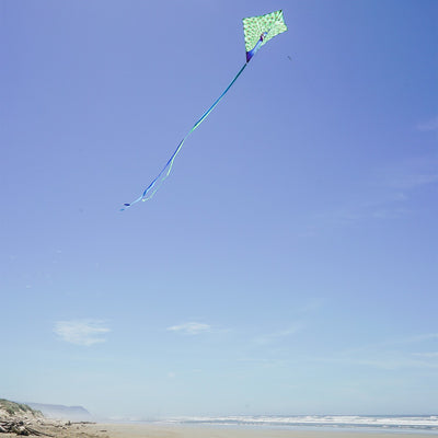 Colorful Peacock 30-inch Diamond Kite flying in the blue sky with vibrant feather design and tails trailing behind, perfect for kids and families.