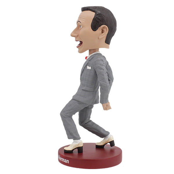 Pee-Wee Herman Bobblehead, standing 7 inches tall in a gray suit and red bowtie, featuring a playful expression, displayed on a decorative shelf.