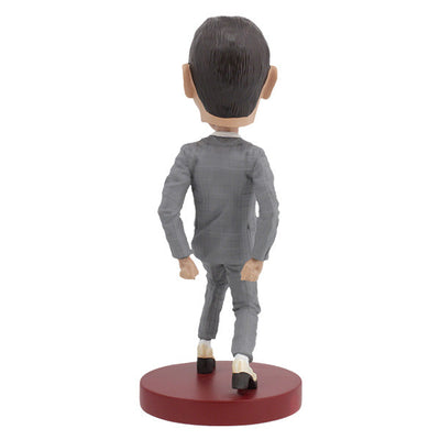 Pee-Wee Herman Bobblehead, standing 7 inches tall in a gray suit and red bowtie, featuring a playful expression, displayed on a decorative shelf.