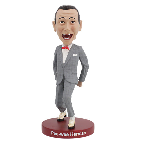 Pee-Wee Herman Bobblehead, standing 7 inches tall in a gray suit and red bowtie, featuring a playful expression, displayed on a decorative shelf.