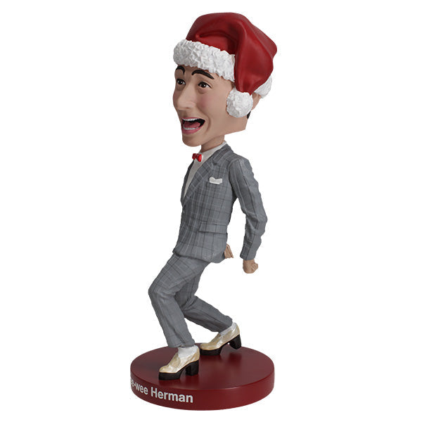 Pee-Wee Herman Holiday Bobblehead featuring the character in a gray suit and red bowtie, standing approximately 7 inches tall on a display surface.