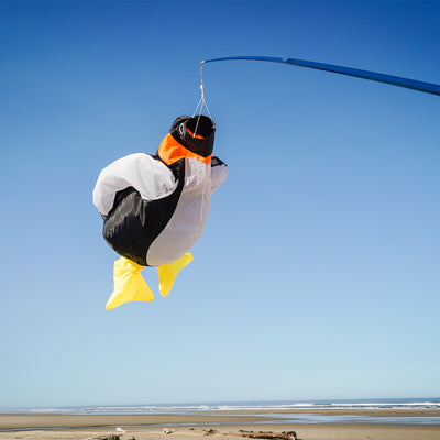 Penguin Big Breeze WindsockTM displayed outdoors showcasing its vibrant colors and 3D body, filled with air as it sways in the breeze.