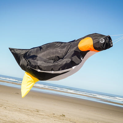 Penguin Big Breeze WindsockTM displayed outdoors showcasing its vibrant colors and 3D body, filled with air as it sways in the breeze.