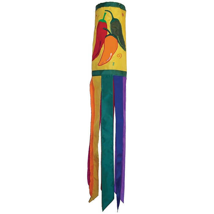 A colorful Pepper Fiesta 40" windsock featuring cheerful chili peppers and fluttering tails hanging gracefully in an outdoor garden setting.