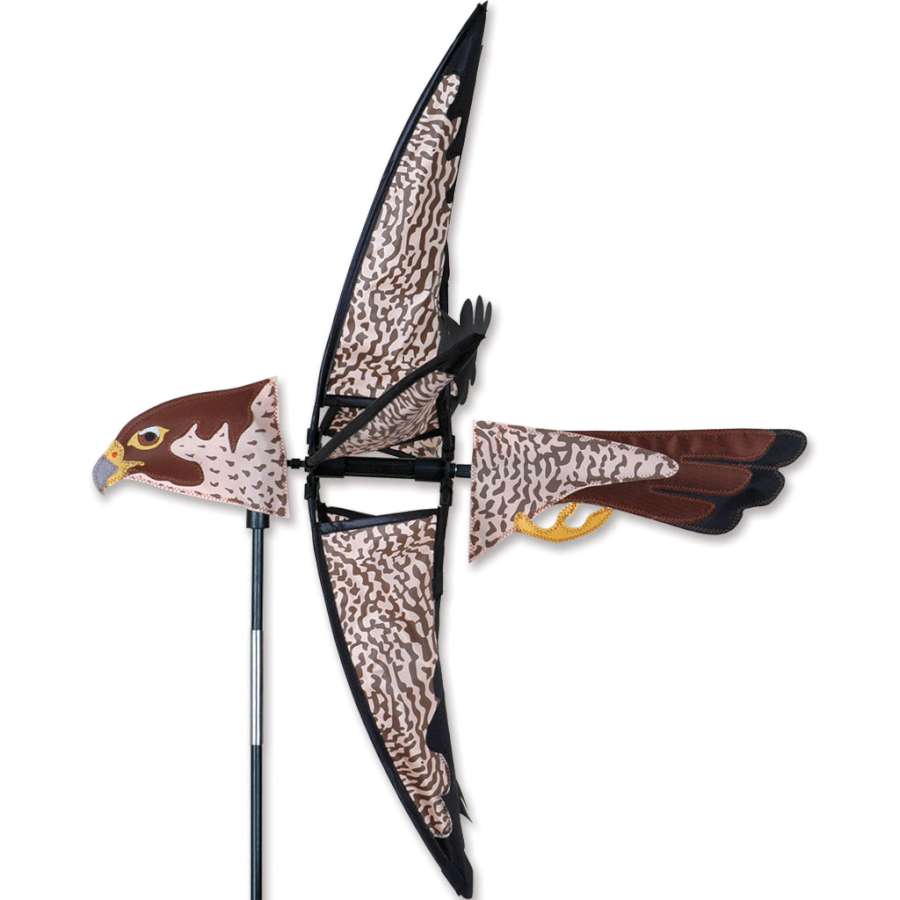 23 in. Peregrine Falcon spinner adorned with vibrant colors, elegantly spinning in a garden setting on a sunny day.