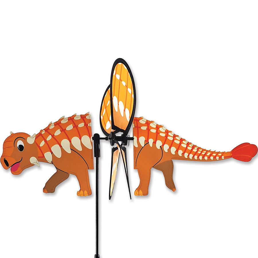 Petite Spinner - Ankylosaurus twirls in the wind with vibrant colors, showcasing its playful design in a picturesque garden setting.