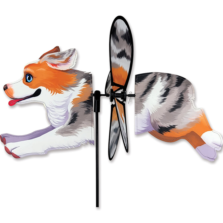 Petite Spinner featuring an Australian Shepherd design twirling in the wind, showcasing its vibrant colors and lightweight structure in a garden setting.