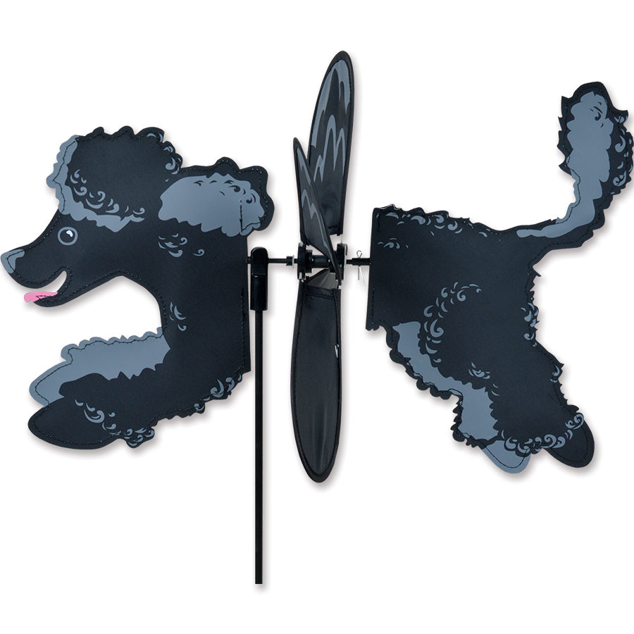 Petite Spinner featuring a playful black poodle design, spinning in a vibrant garden setting with greenery in the background.