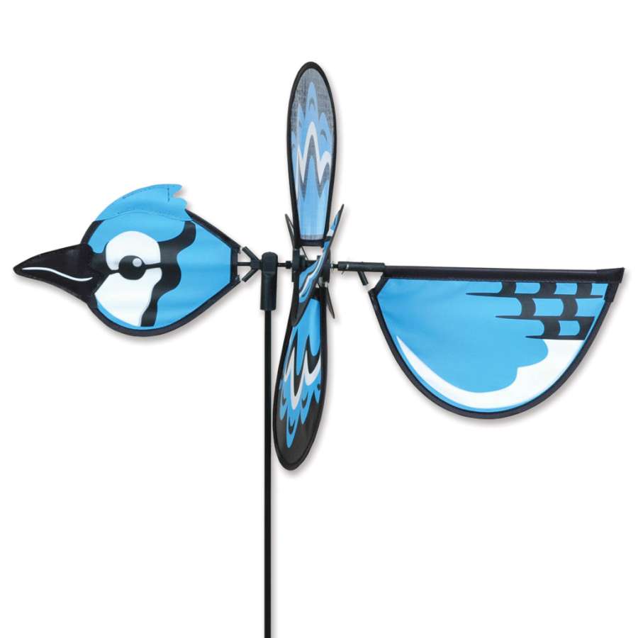 Petite Spinner - Blue Jay featuring vibrant colors and intricate wing design, elegantly spinning in a garden setting on a sunny day.