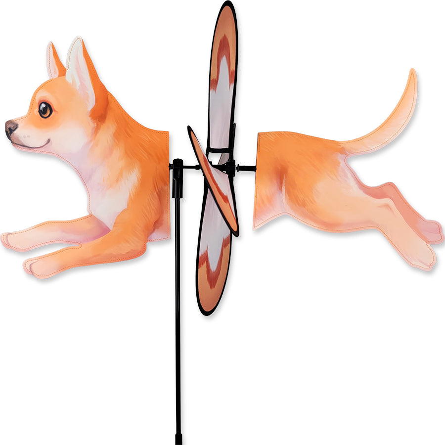 Petite Spinner featuring a Chihuahua design, spinning gracefully in a garden, showcasing vibrant colors against natural greenery.