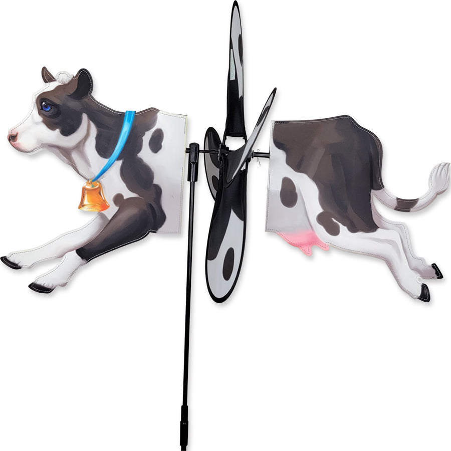 Petite Spinner - Cow in a garden setting, showcasing a colorful design with spinning wings as it sways in the breeze.