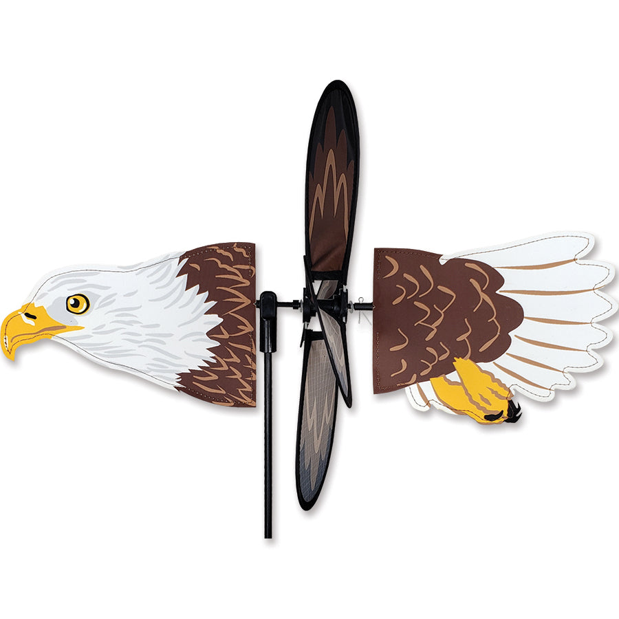 Petite Spinner - Flying Bald Eagle displaying vibrant colors and a majestic eagle design, spinning gently in a garden setting.