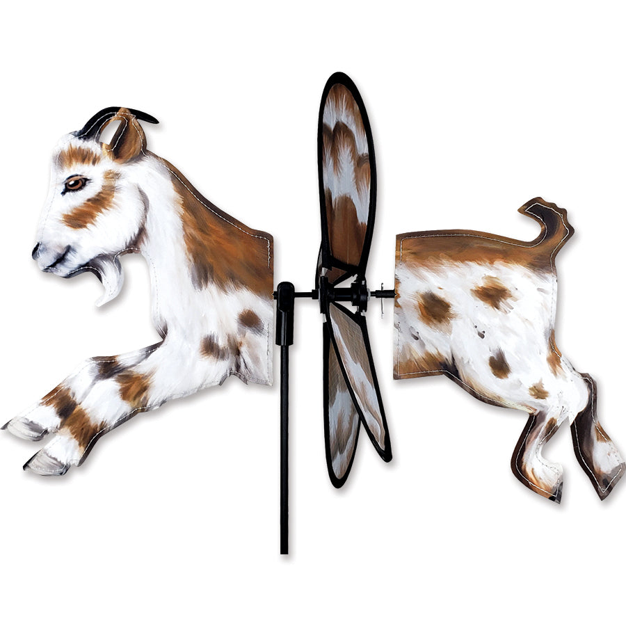 Petite Spinner - Goat features an adorable goat design, captivatingly spinning in a garden setting with colorful fabric.