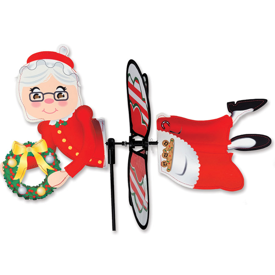 Petite Spinner - Mrs. Claus featuring colorful design, spinning in an outdoor garden setting, adding festive charm to the landscape.