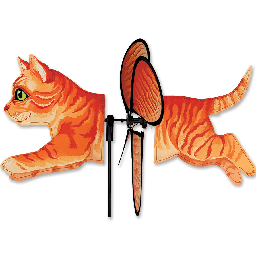 Petite Spinner featuring an orange tabby cat design, elegantly spinning in an outdoor garden setting, showcasing vibrant colors.