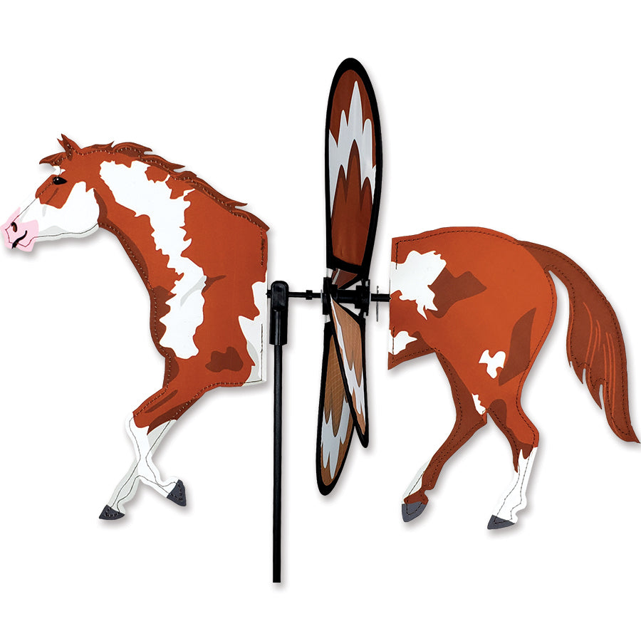 Petite Spinner - Paint Horse decoratively displayed in a vibrant garden setting, showcasing its colorful design and delightful spinning motion.