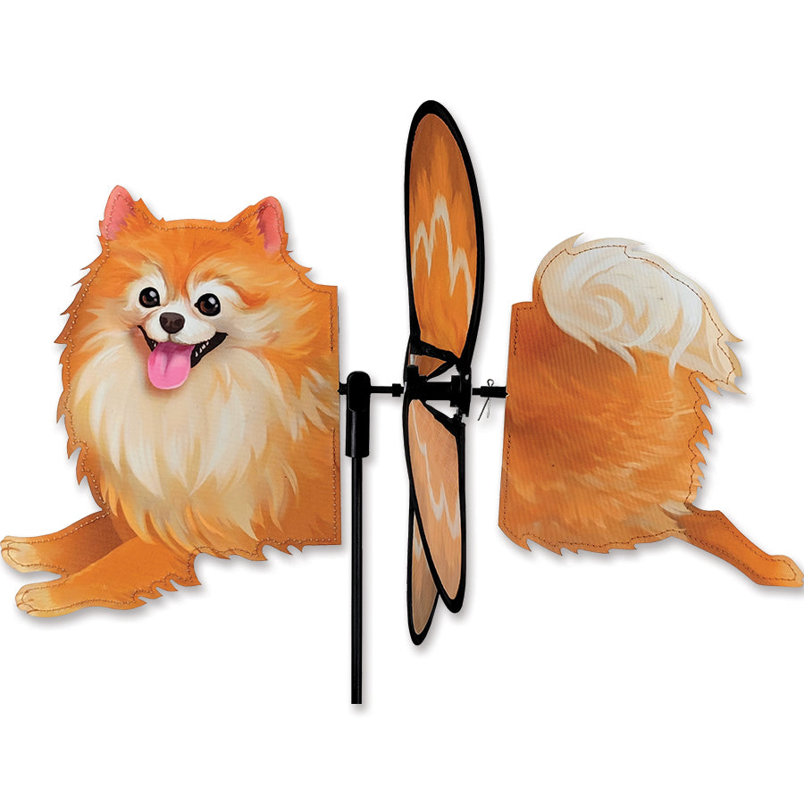 Petite Spinner featuring a colorful Pomeranian design, spinning in the breeze among garden flowers, adding charm and whimsy to the outdoor space.