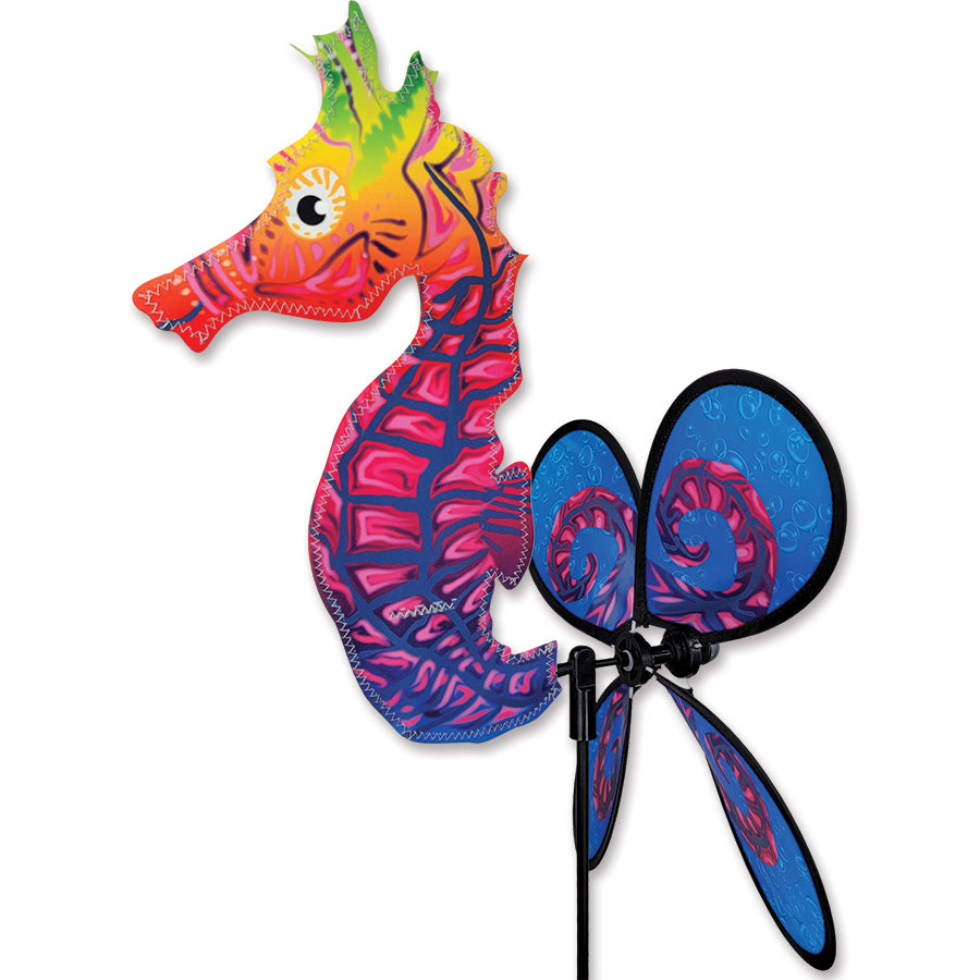 Petite Seahorse spinner in vibrant colors, gracefully twirling in an outdoor garden setting, showcasing its delightful design and compact size.