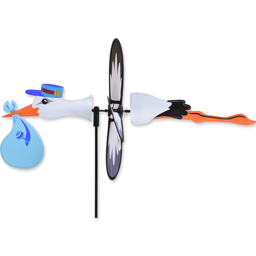 Petite Spinner - Stork Boy in a garden setting, featuring a colorful design with a stork that spins in the breeze.