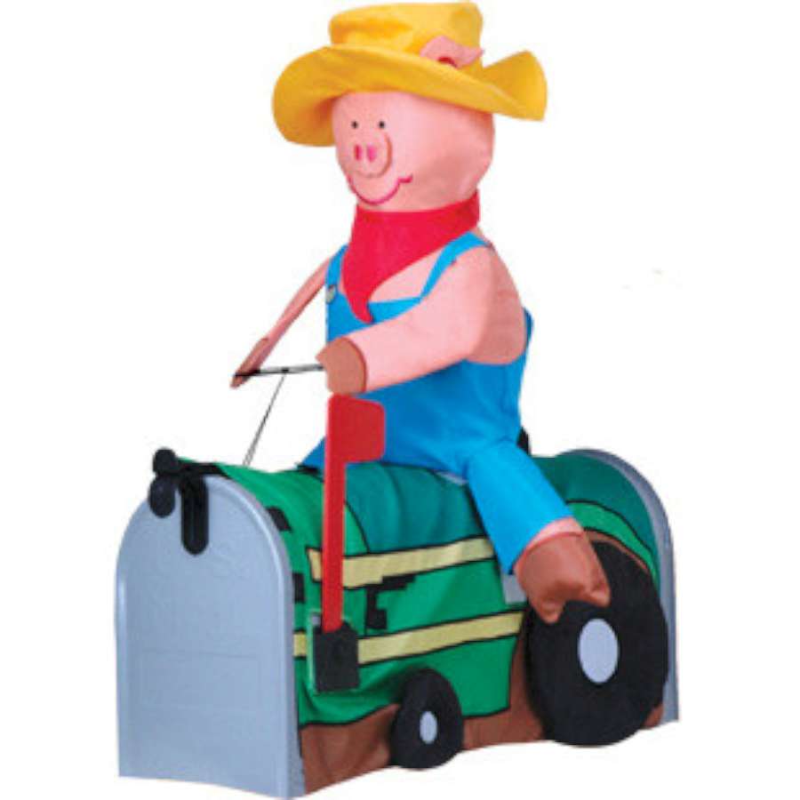 Pig On Tractor mailbox cover featuring a colorful pig driving a bright tractor, displayed on a standard mailbox in a garden setting.