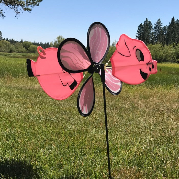Piggy Baby Spinner features a charming baby flying pig design, made with vibrant fade-resistant polyester, twirling beautifully on a fiberglass frame in any outdoor setting.