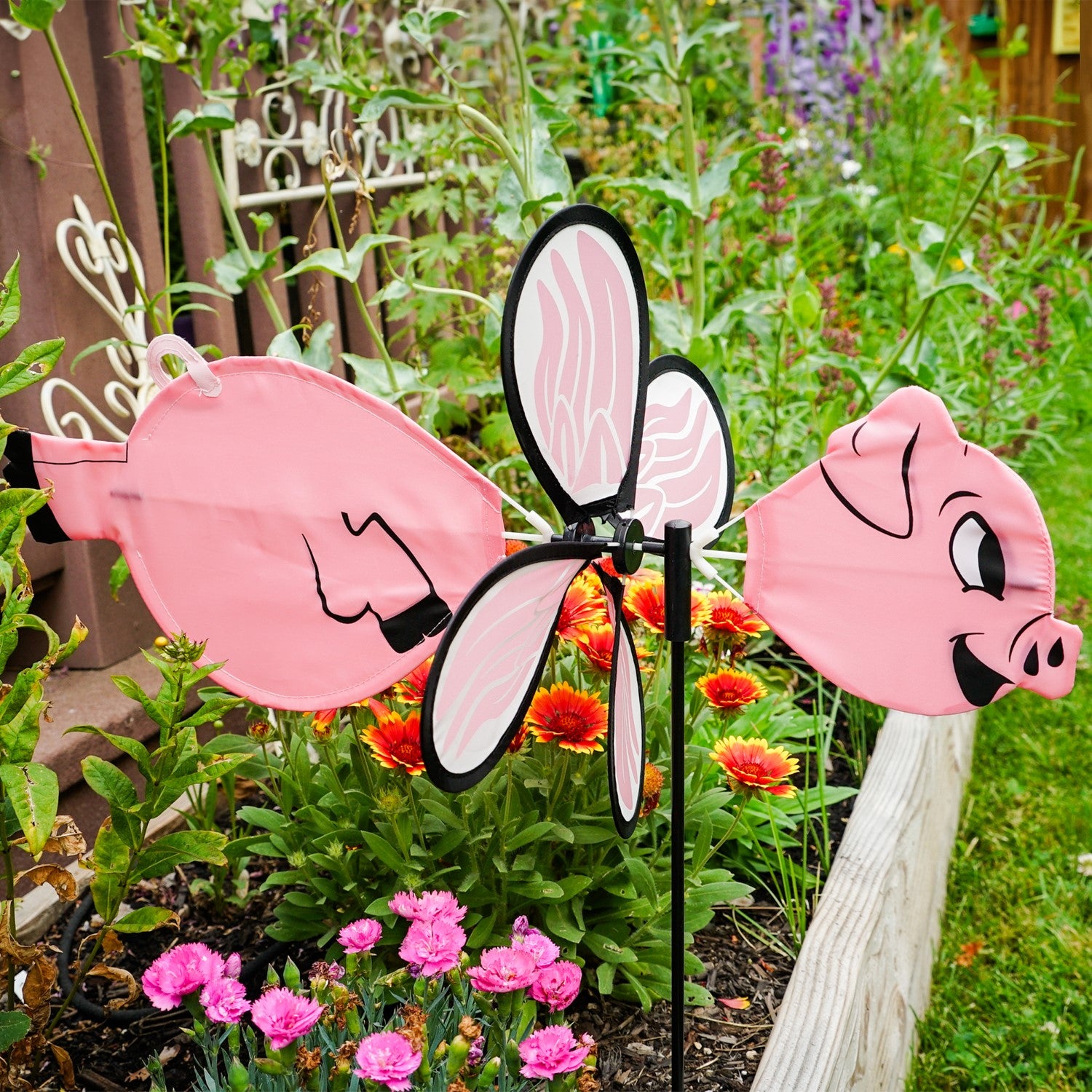 Piggy Baby Spinner features a charming baby flying pig design, made with vibrant fade-resistant polyester, twirling beautifully on a fiberglass frame in any outdoor setting.