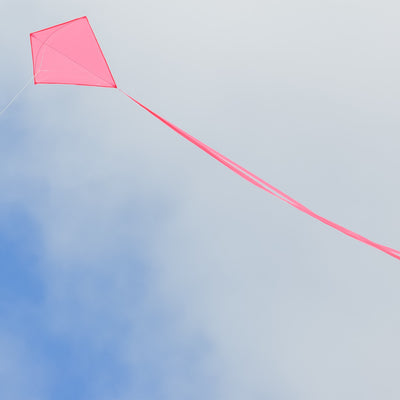 Pink Colorfly 30-inch Diamond Kite flying in a clear blue sky with three long pink tails, ideal for family outdoor activities.