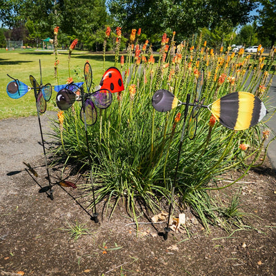 Pivoting Bumble Bee Bug Spinner with vibrant bumble bee design and iridescent wings displayed in an outdoor garden setting, spinning in the wind.