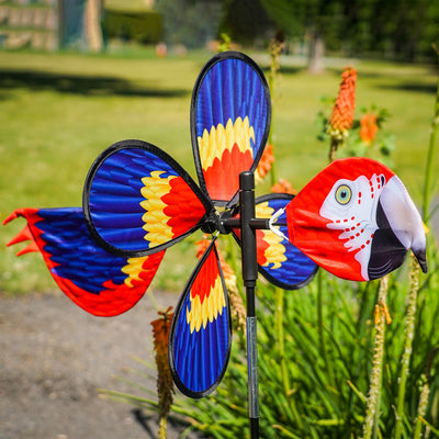 The Pivoting Parrot Bird Spinner showcases a vivid design of a parrot, spinning gracefully in the wind, adding a splash of color to your outdoor space.