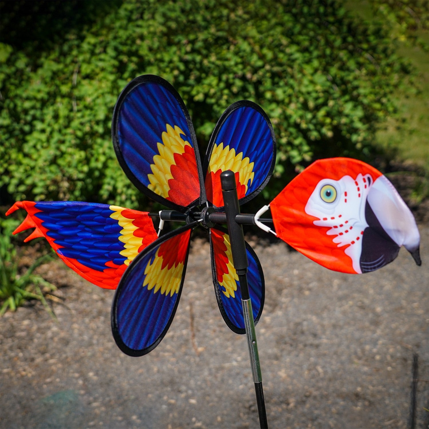The Pivoting Parrot Bird Spinner showcases a vivid design of a parrot, spinning gracefully in the wind, adding a splash of color to your outdoor space.