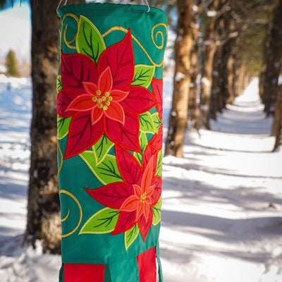 Poinsettia 40" Windsock displaying vibrant red flowers and colorful tails, fluttering in the wind, perfect for winter holiday outdoor decoration.