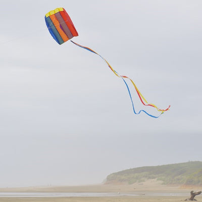 Pouch Parafoil Kite flying majestically in a partly cloudy sky, featuring vibrant rainbow colors and a streamlined design for easy flight.