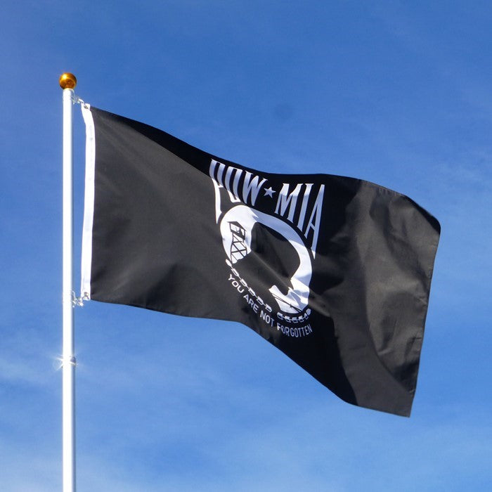 POW/MIA 3x5 Grommet Flag displayed on a flag pole outdoors, showcasing the vibrant design dedicated to honoring military service members.