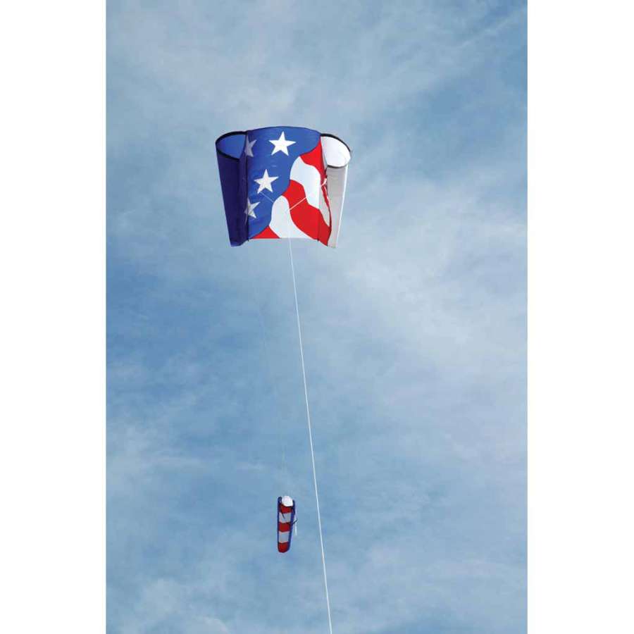 Power Sled 14 Kite soaring high in the sky, showcasing vibrant colors and a sleek design, measuring 63 x 40 inches.