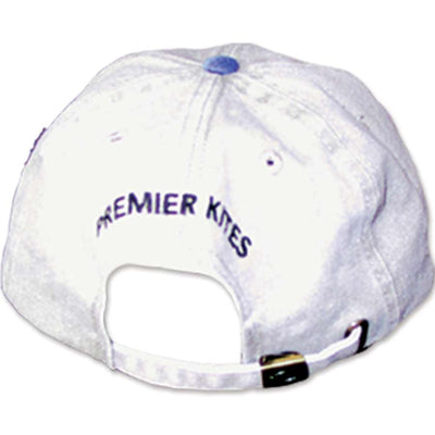 Premier Baseball Cap featuring a prominent logo, designed for outdoor use, displayed on a picnic table under bright sunlight.