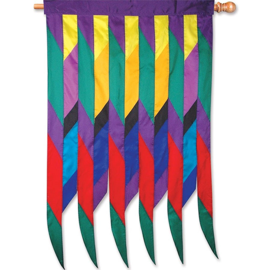 Progressive Banner - Cellon Passion with vibrant Native American-inspired designs displayed on an outdoor flag pole in a garden setting.