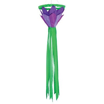 Purple 38 inch lotus flower windsock with bright petals and flowing green tails, elegantly displayed in a garden setting, showcasing its colorful design.