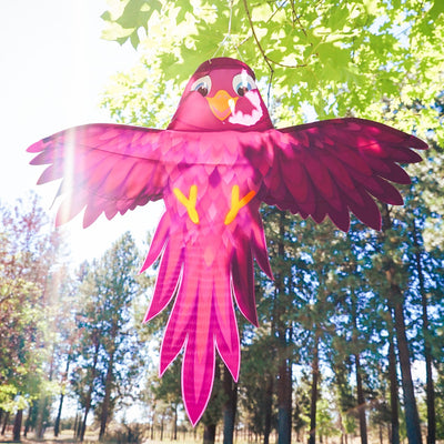 Colorful Purple Bird Windsock with spread wings fluttering in a gentle breeze, showcasing vibrant purple hues in an outdoor setting.