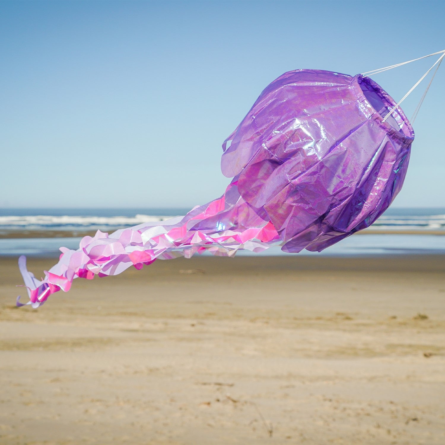 40-inch Purple Iridescent Jellyfish 3D Windsock with colorful tentacles fluttering in the wind, showcasing its lifelike design.