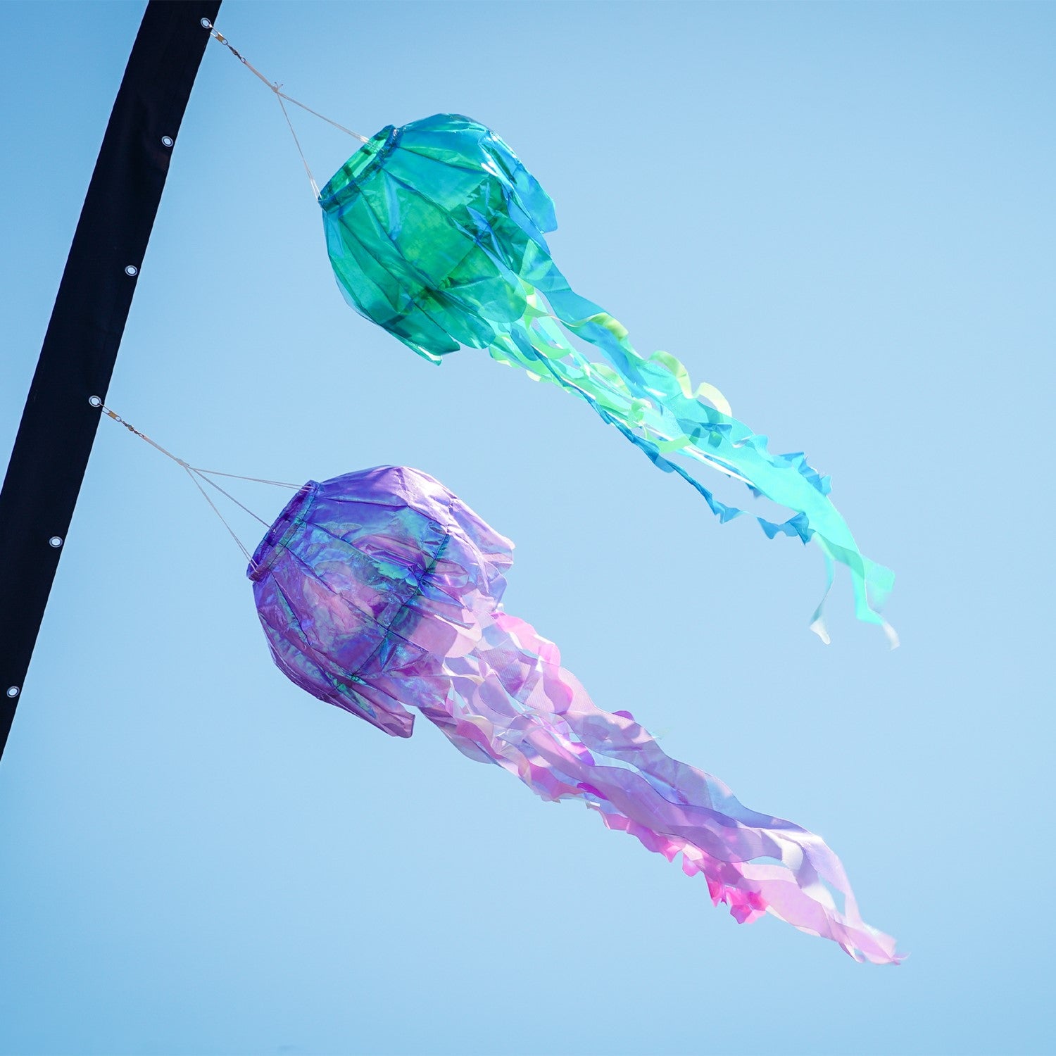 40-inch Purple Iridescent Jellyfish 3D Windsock with colorful tentacles fluttering in the wind, showcasing its lifelike design.