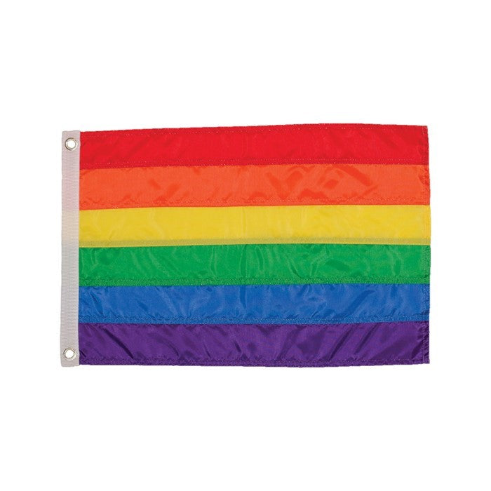 Rainbow 12x18 grommet flag with bright colors, mounted on a flagpole outside, showcasing vibrant panels in a sunny setting.